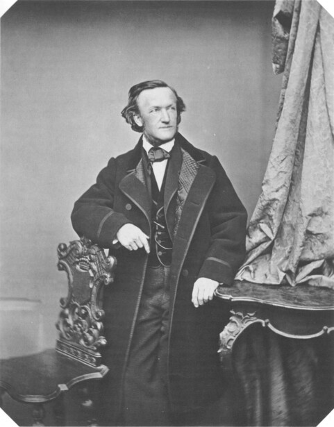 Portrait photograph of a seated man in formal 19th-century attire with dark coat and vest.