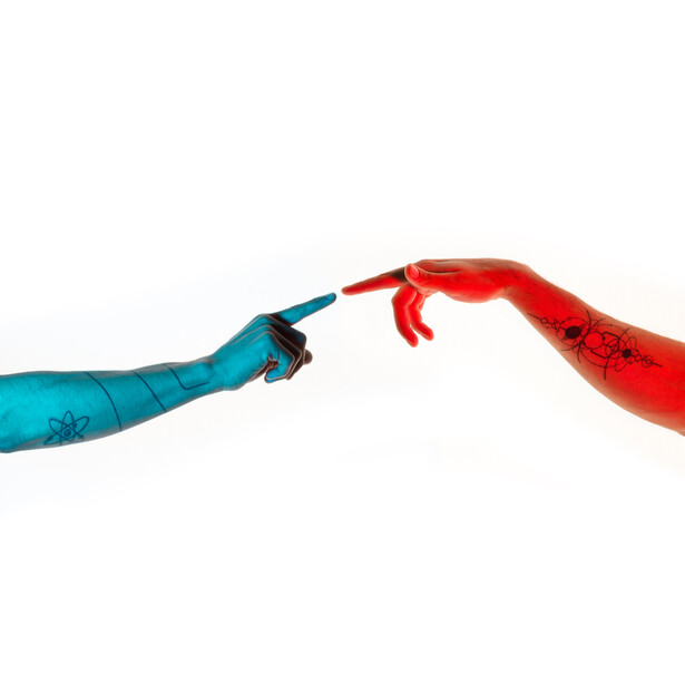 Two painted arms reaching toward each other against white background, one blue and one red.