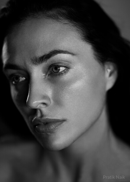Black and white portrait of a woman with defined facial features and direct gaze.