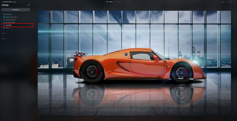Orange sports car photographed in profile against floor-to-ceiling windows with city skyline backdrop.