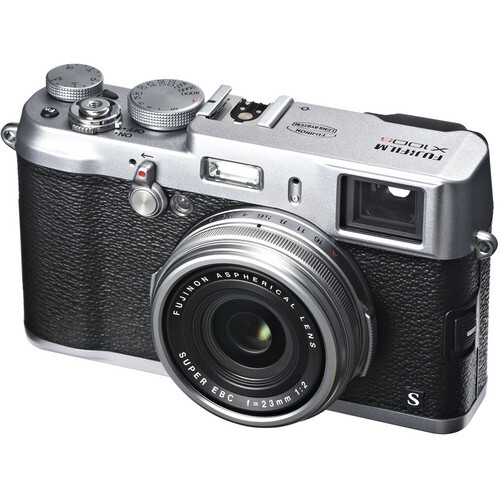 Silver and black rangefinder camera with dual top-mounted dials and fixed prime lens against white background.