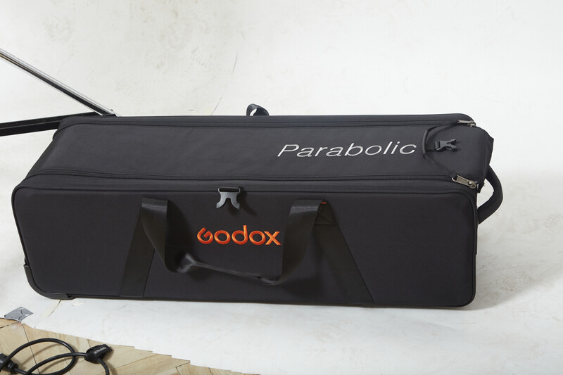 Godox Parabolic softbox with carrying case and power cable on white surface.