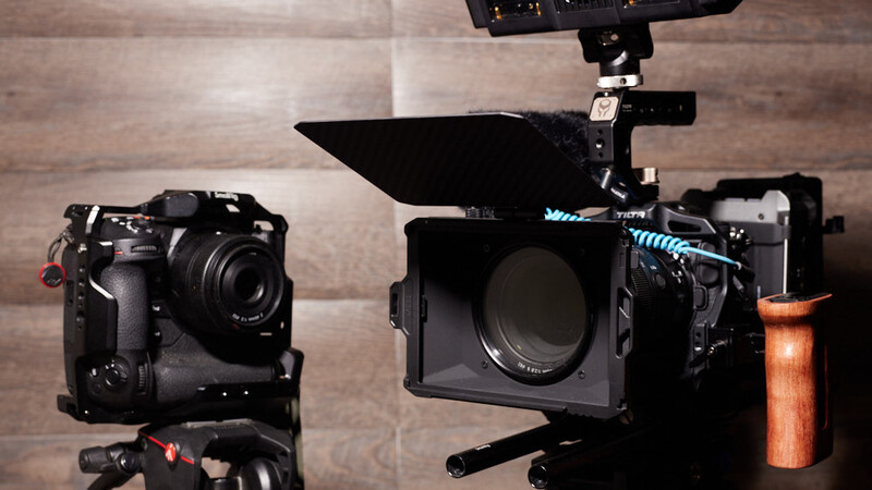 Professional cinema camera rig with matte box and follow focus system alongside compact mirrorless camera body.