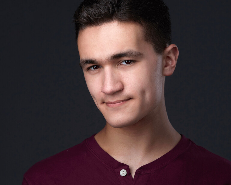 A headshot of Jacob, an actor.