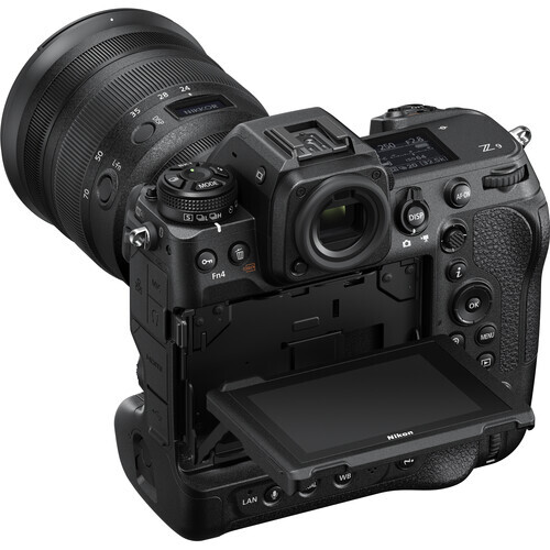 Professional cinema camera with attached telephoto lens and articulating monitor mounted on top.