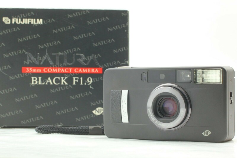 Fujifilm Black F1.9 compact camera with original box and wrist strap displayed.