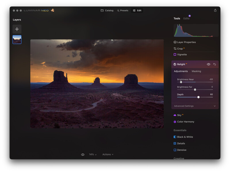 Screenshot of photo editing software showing a desert landscape at sunset with three rock formations silhouetted against an orange sky.
