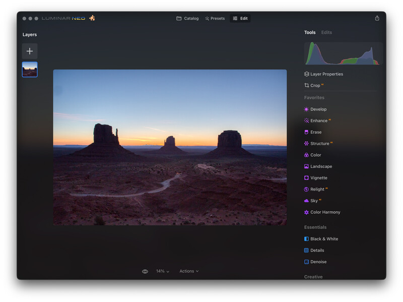 Screenshot of photo editing software showing a desert landscape with rock formations at sunset.
