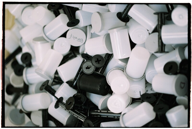 Black camera body surrounded by white and black plastic lens caps.
