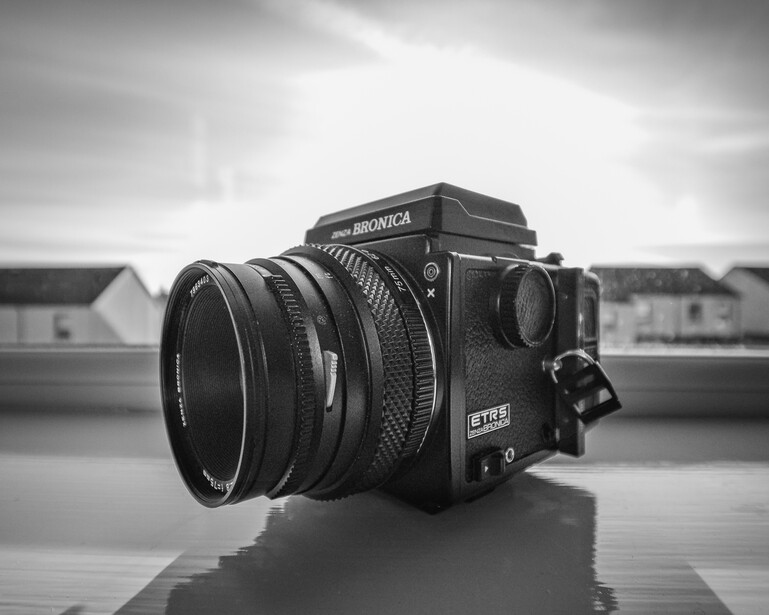 Bronica SQ series medium format camera with wide-angle lens on reflective surface.