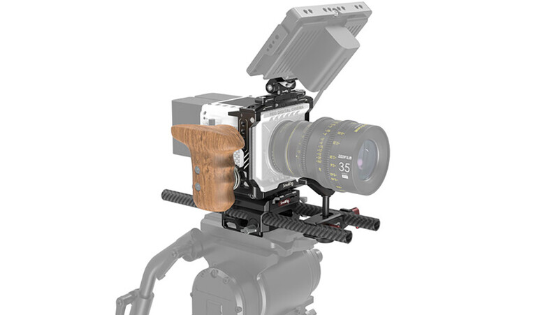 Cinema camera mounted on a support rig with wooden handgrips, monitor, and matte box attachment.