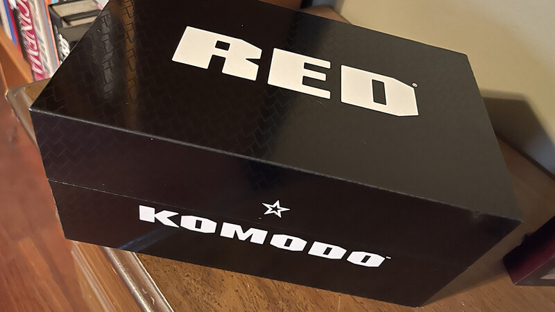 Black branded box with white block lettering and star logo on wooden surface.
