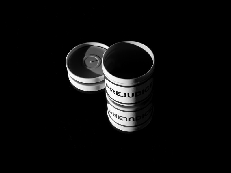 Two cylindrical film canisters with white bands and labels photographed against a black background.