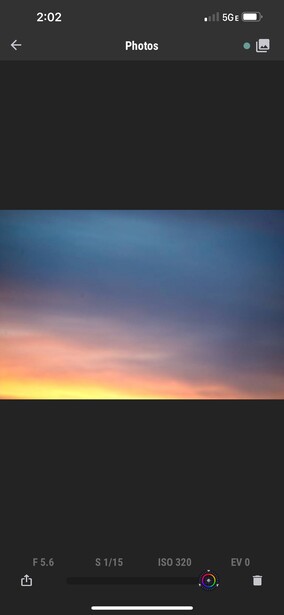 Gradient sunset sky transitioning from deep orange near horizon to pink and blue higher up.
