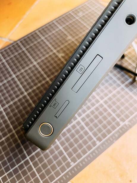 Top-down view of a laptop's keyboard and trackpad area with textured background fabric.