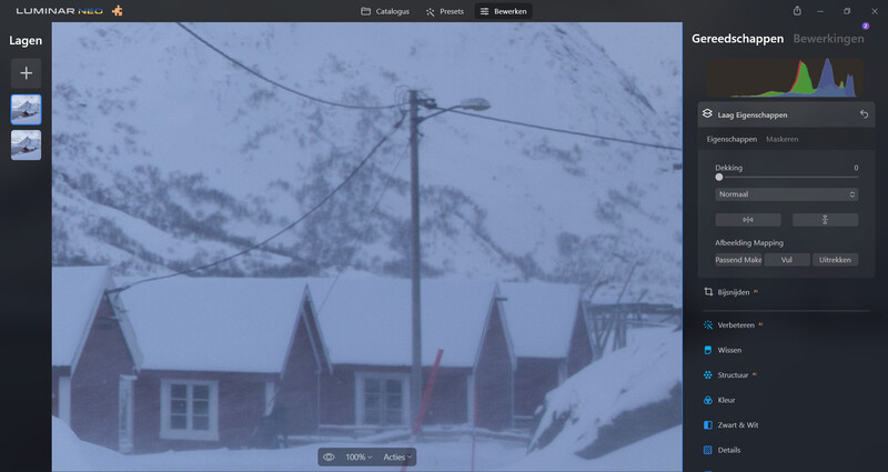 Screenshot of photo editing software showing a snowy mountain village with red buildings.