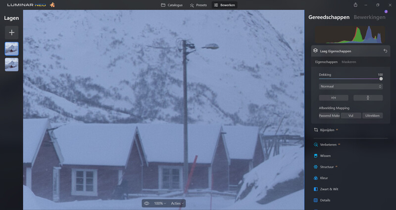 Screenshot of photo editing software displaying snowy mountain landscape with traditional buildings.