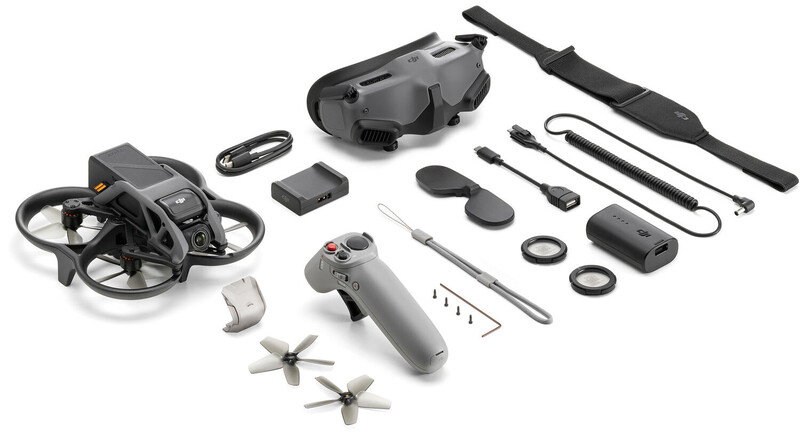 Flat lay of drone and accessories including controller, batteries, propellers, and cables.