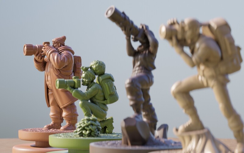 Three sculptural figurines displayed with shallow depth of field, foreground figure in sharp focus.