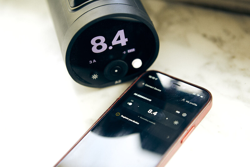 Smartphone displaying camera app with f/8.4 aperture setting next to lens with matching f/8.4 display.