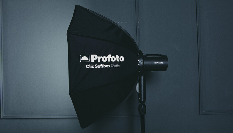 Profoto Clic Softbox Light reflector mounted on studio lighting equipment against gray backdrop.
