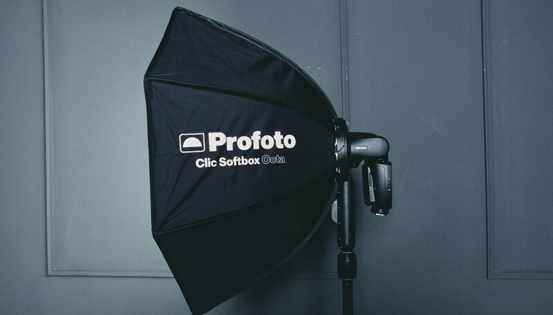 Profoto Clic Softbox mounted on a studio flash head against a gray backdrop.