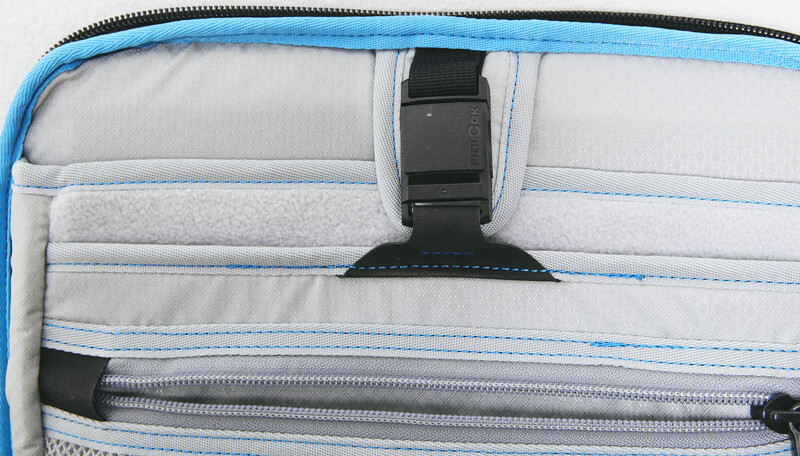 Interior view of a camera bag showing padded dividers and elastic straps for organizing gear.
