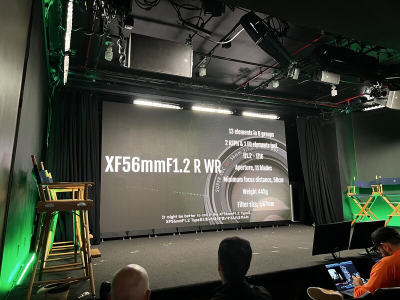 Projection screen displaying XF56mmF1.2 R WR lens specifications at a photography event.