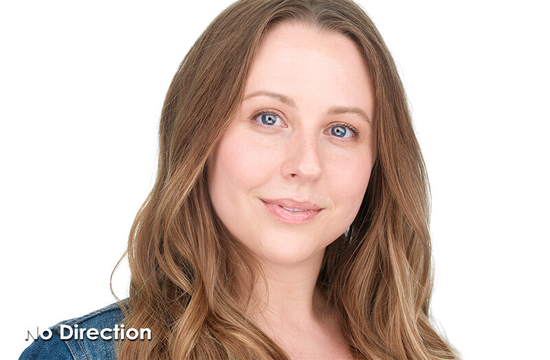 Woman with long brown hair and blue eyes looking at camera against white background.