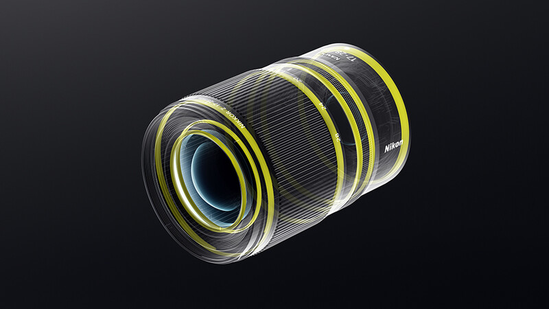 Illustration of a camera lens with yellow accent rings and internal glass elements visible against a dark background.