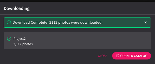 Screenshot of a download completion dialog showing 2,112 photos successfully downloaded to Project2.