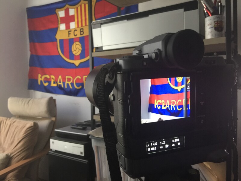 Professional video camera on tripod with monitor displaying FC Barcelona flag logo in studio setting.