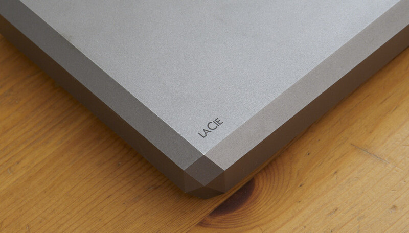 LaCie external hard drive positioned on wooden floor, showing corner detail and branding.