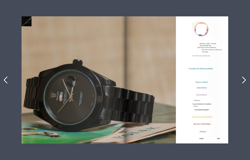 Black analog watch with metal band resting on colorful magazine pages.