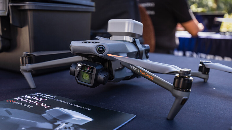 DJI Mavic 3 drone displayed on table with gimbal camera and remote controller visible.