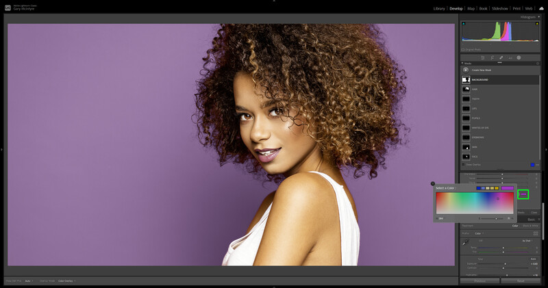 Woman with voluminous curly hair against purple background, shot in studio lighting.