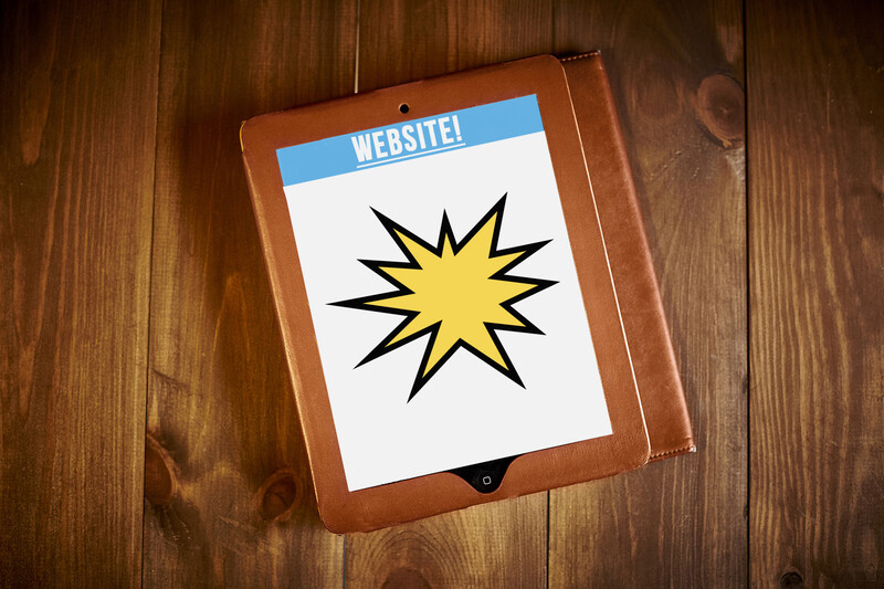 Tablet displaying yellow starburst graphic on wooden surface with blue "Website" header label.