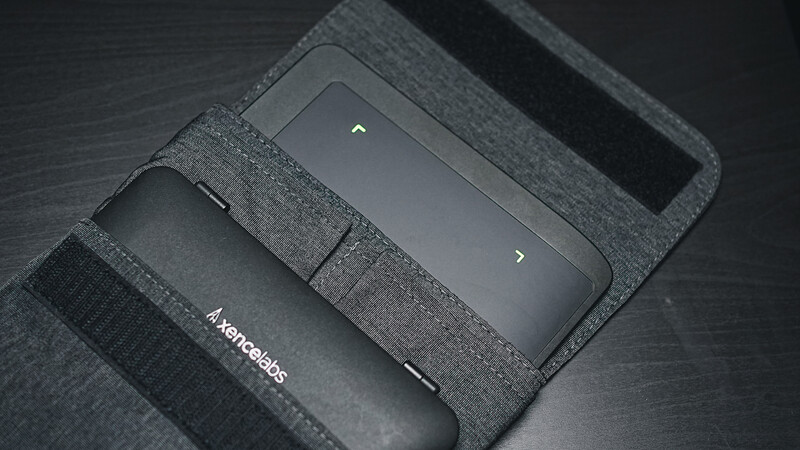 Camera gear organized in a gray fabric storage case with multiple compartments and elastic straps.