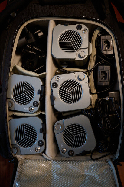 Open gear case with six white fan units and black cables organized in compartments.