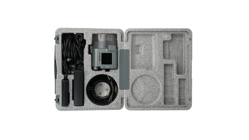 Professional camera equipment kit organized in gray foam case with storage compartments.