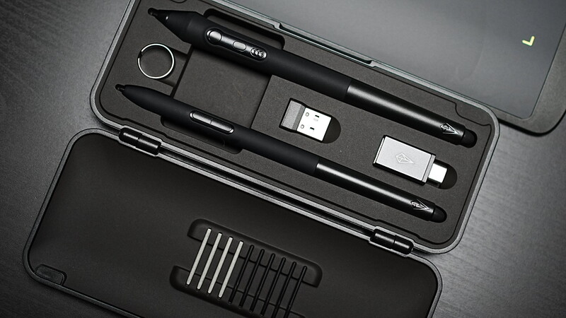 Creative professional kit with stylus pens, precision tools, and small screwdriver set arranged in organized black cases.
