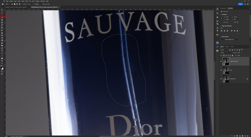 Screenshot of photo editing software displaying a luxury fragrance bottle with blue gradient lighting and text overlay.