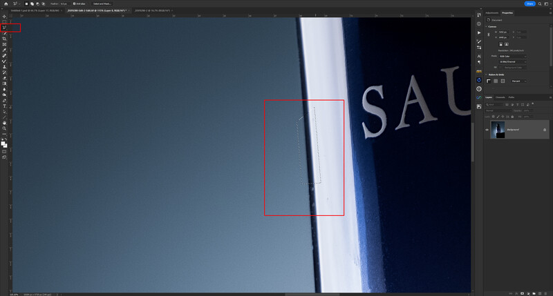 Screenshot of Adobe Photoshop with a rectangular selection tool active on an image featuring blue and white geometric shapes.