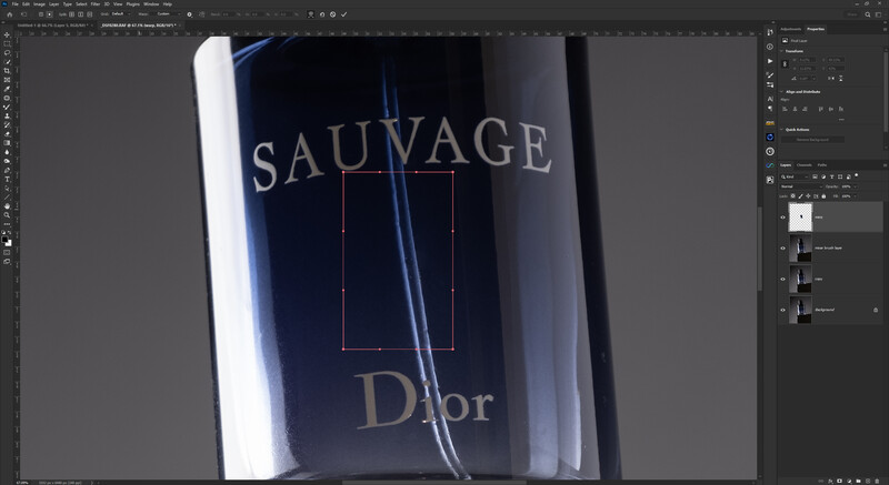 Screenshot of Photoshop showing a luxury fragrance bottle with Sauvage and Dior branding displayed in editing workspace.