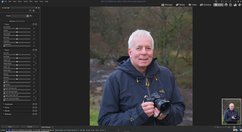 Older man with white hair holding a professional camera outdoors in natural daylight.
