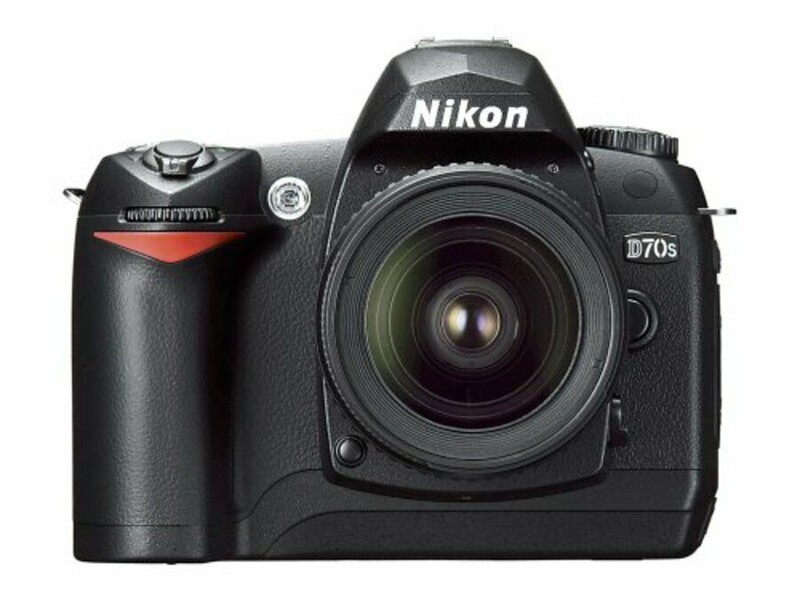 Nikon D70s DSLR camera with attached lens, front-facing view against white background.