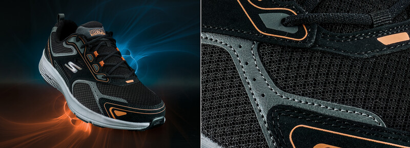 Athletic sneaker with black mesh upper, orange accents, and white sole photographed against glowing blue and orange light effects.