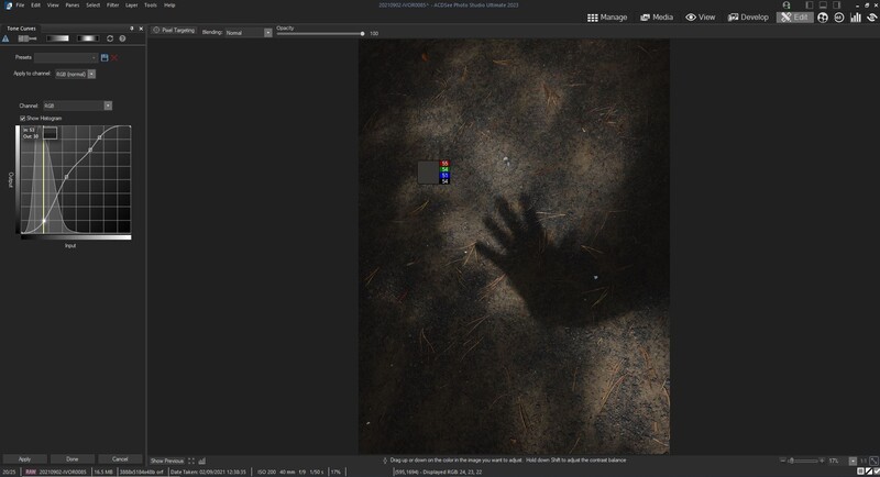Dark, textured portrait of a hand pressed against a gritty surface with blue light accent.