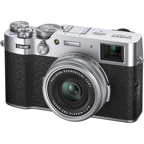 Fujifilm X100V rangefinder camera with silver body, black leather grip, and fixed prime lens.