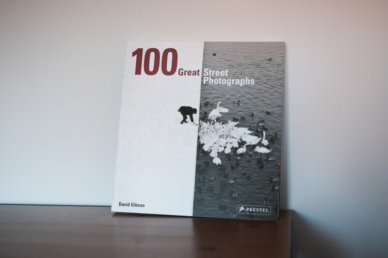 Book cover for "100 Great Street Photographs" by David Gibson, displayed against a neutral background.